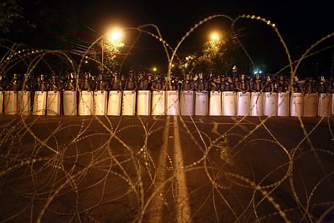 Riot police block the street towards the Presidential Residence to prevent a march of anti-government protesters, supporters of the armed group who have been holed inside a police station, in Yerevan, Armenia. (AP)