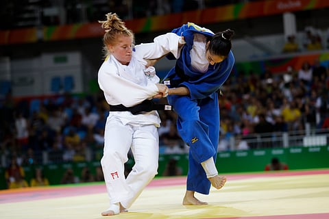 Ghana's Szandra Szogedi, white, competes against Brazil's Mariana Silva during the women's 63-kg judo competition at the 2016 Summer Olympics in Rio de Janeiro, Brazil, Tuesday, Aug. 9, 2016. | AP