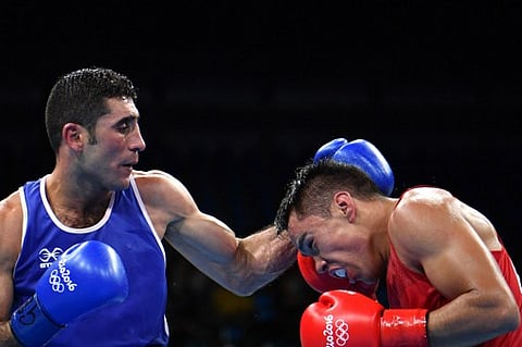 Iraq's Waheed Abdulridha Waheed Karaawi (L) lands a punch on Mexico's Misael Uziel Rodriguez during the Men's Middle (75kg) match at the Rio 2016 Olympic Games at the Riocentro - Pavilion 6 in Rio de Janeiro on August 9, 2016. | AFP