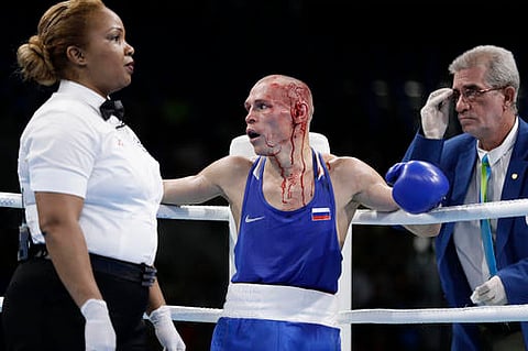 Referee stops the fight to have Russia's Nikitin Vladimir's cuts treated as Vladimir fights Vanuatu's Boe Warawara during a men's bantamweight 56-kg preliminary boxing match. (AP)