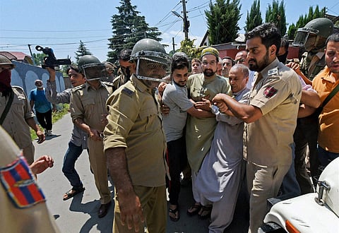 Police detain senior separatist leader of Moderate Faction of Hurriyat Conference Mirwaiz Molvi Umar Farooq after he jumps from his gate to defy the curfew in Srinagar on Saturday. | PTI