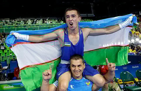 Uzbekistan's Hasanboy Dusmatov celebrates after winning the gold medal for the men's light flyweight 49-kg final boxing match at the 2016 Summer Olympics in Rio de Janeiro. (AP)