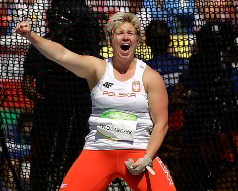 Poland's Anita Wlodarczyk celebrates after setting a new world record in the women's hammer throw final during the athletics competitions in the Olympic stadium of the 2016 Summer Olympics in Rio de Janeiro, Brazil, Monday, Aug. 15, 2016. | AP