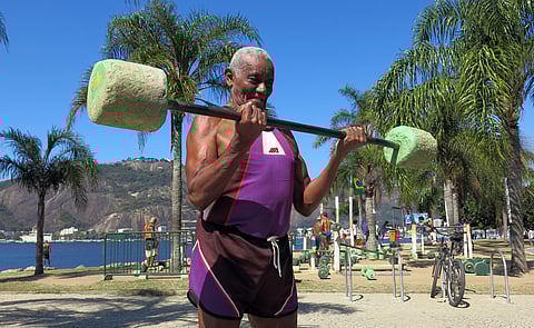 Jose Rebamar, 75, lifts weights at an outside gym in Rio de Janeiro, Brazil, Sunday, Aug. 14, 2016. With near daily sunshine and warm weather all year, the former Brazilian Navy sailor says there is no excuse to ever slow down. | AP