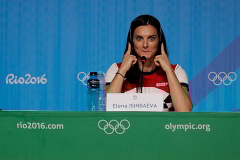 Yelena Isinbayeva, Russia's pole vault world record holder, reacts as she listens to a translation of a question during a news conference at the 2016 Summer Olympics in Rio de Janeiro, Brazil, Friday, Aug. 19, 2016. | AP