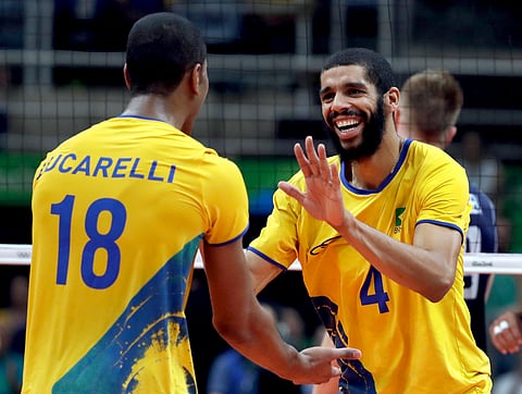 Brazil's Wallace de Souza (4) celebrates with teammate Ricardo Lucarelli during a men's gold medal volleyball match at the 2016 Summer Olympics in Rio de Janeiro, Brazil, Sunday, Aug. 21, 2016. | AP