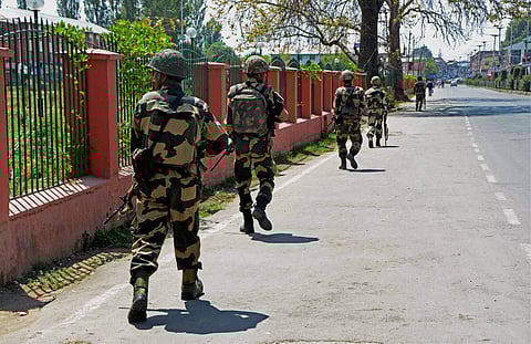 Security jawans patrolling during Curfew and strike in Srinagar on Wednesday. PTI