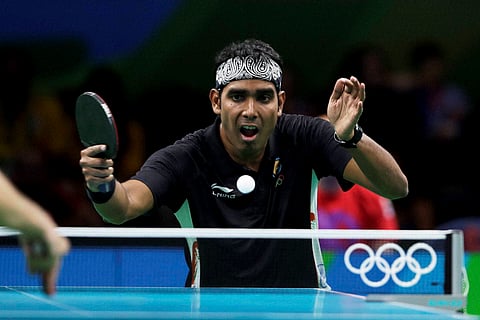 Achanta Sharath Kamal of India plays against Adrian Crisan of Romania during their table tennis match at the 2016 Summer Olympics in Rio de Janeiro Brazil Saturday Aug. 6 2016. | AP