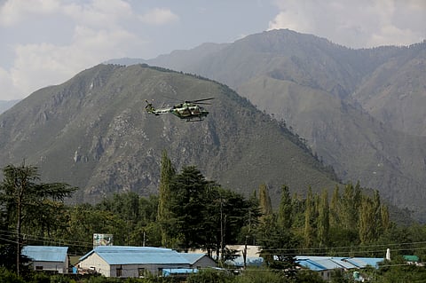 An Indian army helicopter flies above the army base which was attacked by suspected rebels in the town of Uri, west of Srinagar, Kashmir, Sunday, Sept. 18, 2016. | AP