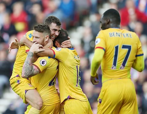 Crystal Palace's James McArthur, top left, celebrates with team mates after scoring a goal against Sunderland during their English Premier League soccer match at The Stadium of Light, Sunderland, England, Saturday Sept. 24, 2016. | AP