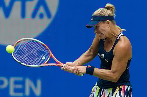 Angelique Kerber of Germany hits a return while playing against Kristina Mladenovic of France during the WTA Wuhan Open in Wuhan in central China's Hubei province Tuesday, Sept. 27, 2016. | AP