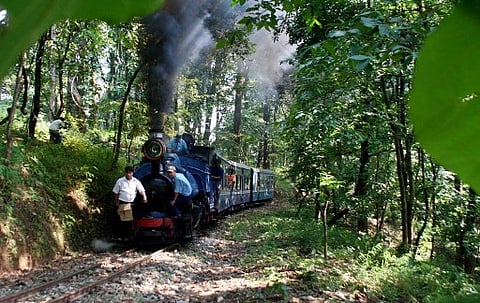In this file picture, a train of the Darjeeling Himalayan railway (DHR), also known as the Toy Train, moves along the track on its way to the hill station of Darjeeling. (Photo | AFP)