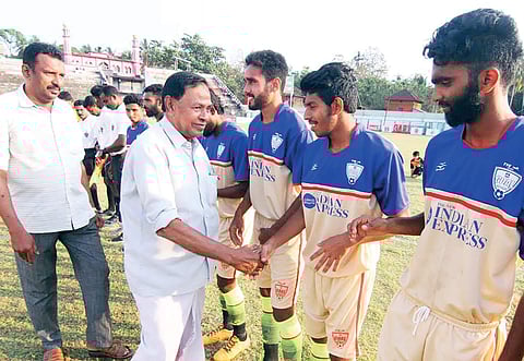 Malappuram District Football Association vice-president C K Abdurahman greeting players from Sree Vyasa NSS College, Wadakkanchery, and MG College, Thiruvananthapuram, before the start of the match