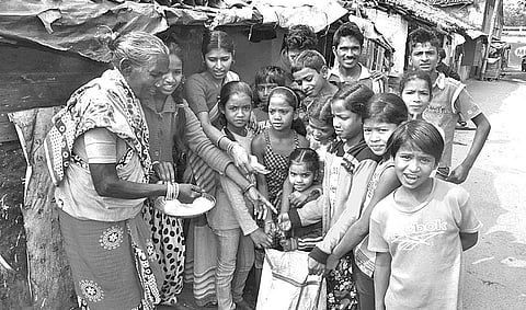 Children collecting food materials from households in Sambalpur on Thursday | Express