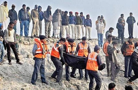 NDRF personnel recovering the body of a passenger from a boat which capsized in the river Ganga, in Patna on Sunday. The death count in the tragedy rose to 24 on Sunday. | PTI