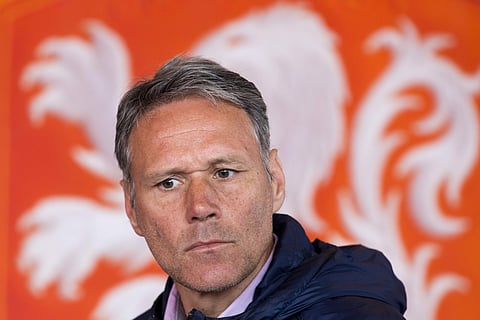 Dutch former soccer star Marco van Basten is seated in front of the logo of the Dutch soccer association KNVB during a presentation. | AP