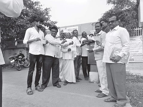 Villagers posting their letters to President Pranab Mukherjee at a local post office in Vemulaghat on Thursday | Express photo