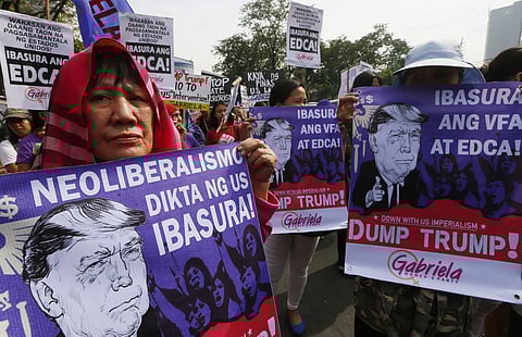 Protesters display 'Dump Trump' placards prior to marching towards the US Embassy for a rally to coincide with the inauguration of President-elect Donald Trump as the 45th President of the United States, Friday, Jan. 20, 2017, in Manila, Philippines. | AP