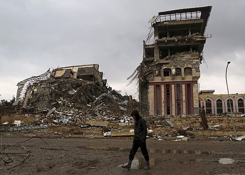 A student walks past badly damaged buildings at the University of Mosul, that was recently liberated from Islamic State militants, on the eastern side of Mosul, Iraq, Sunday, Jan. 22, 2017. (Photo |AP)