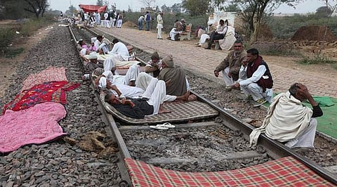 People lie down on tracks during an earlier Jat quota agitation in Haryana. | File Photo
