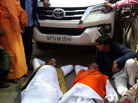 Miffed with ticket distribution BJP leaders, Sunder Lal Dixit and Rambabu Dwivedi lie down in front of BJP UP chief Keshav Prasad Maurya's car . (ANI)