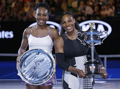 United States' Serena Williams, right, and her sister, Venus, pose for a photo after Serena won the women's singles final at the Australian Open tennis championships in Melbourne. | AP
