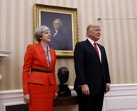 President Donald Trump stands with British Prime Minister Theresa May, Friday, Jan. 27, 2017, in the Oval Office of the White House in Washington. | AP