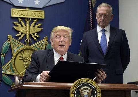 President Donald Trump, left, with Defense Secretary James Mattis, right, watching, explains the executive action on extreme vetting that he is about to sign at the Pentagon in Washington, Friday, Jan. 27, 2017. | AP
