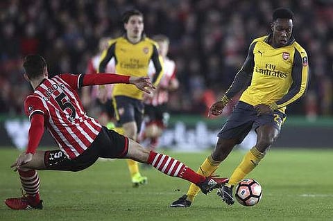Arsenal's Danny Welbeck, right, and Southampton's Florin Gardos battle for the ball during the Emirates FA Cup, fourth round soccer match at St Mary's Stadium. | AP