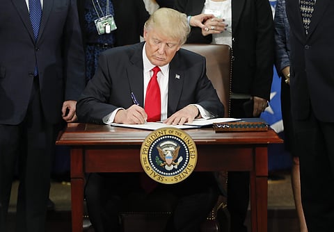 In this Jan. 25, 2017, photo, President Donald Trump signs an executive order for border security and immigration enforcement improvements at the Department of Homeland Security in Washington. | AP