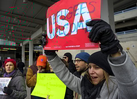 Protesters assemble at John F. Kennedy International Airport in New York, Saturday, Jan. 28, 2017 after two Iraqi refugees were detained while trying to enter the country. | AP