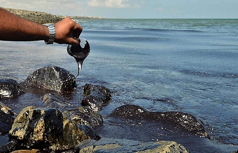 Thick oil from the sea doesn’t easily flow out of a plastic cup at Bharatiyar Nagar. (Photo | EPS)