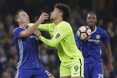 Chelsea's John Terry, left vies with Peterborough United's Lee Angol during the English FA Cup third round soccer match between Chelsea and Peterborough United at Stamford Bridge stadium in London. | AP