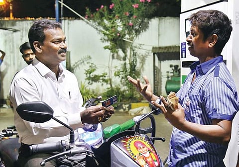A customer haggles with a worker at a petrol pump over mode of payment on Sunday | Romani Agarwal