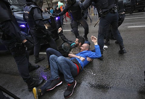 Three man hold to each other as they try to block a Spanish police van from approaching a voting site to prevent would-be voters from voting in Barcelona, Spain on Oct. 1, 2017. (Photo | AP)