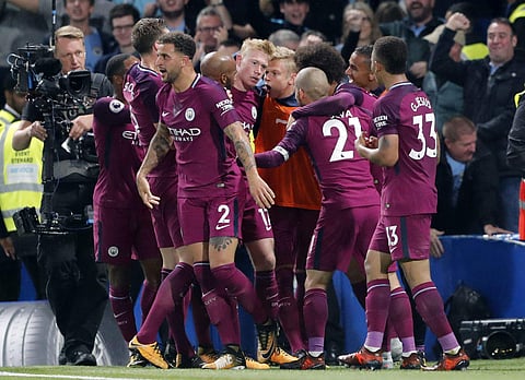Manchester City's scorer Kevin De Bruyne, center, and his teammates celebrate the opening goal during their English Premier League soccer match between Chelsea and Manchester City at Stamford Bridge. | AP