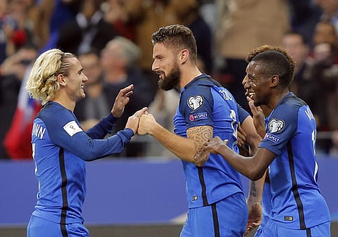 France's Olivier Giroud, center, celebrates his goal with teammate Antoine Griezmann, left, during the World Cup Group A qualifying soccer match between France and Belarus at the Stade de France stadium in Saint-Denis, outside Paris, Tuesday, Oct.10, 2017