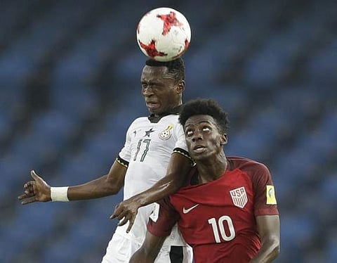 Ghana's Rashid Alhassan, right,and U.S's Tim Weah jump for a header during their FIFA U-17 World Cup match in New Delhi, India, Monday, Oct. 9, 2017. | AP