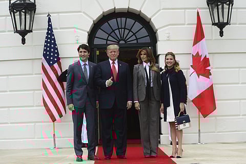 Canadian Prime Minister Justin Trudeau and his wife Sophie Gregoire Trudeau are welcomed to the White House by US President Donald Trump and his wife Melania (AP)