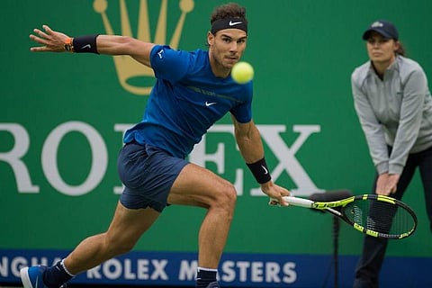Rafael Nadal of Spain hits a return against Grigor Dimitrov of Bulgaria during their men's singles quarter-final match at the Shanghai Masters tennis tournament in Shanghai on October 13, 2017.|AFP