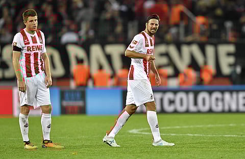 Cologne's Dominique Heintz and Claudio Pizarro, from left, leave the pitch disappointed after losing the German Bundesliga soccer match between 1. FC Cologne and RB Leipzig in Cologne, Germany, Sunday, Oct. 1, 2017. | AP