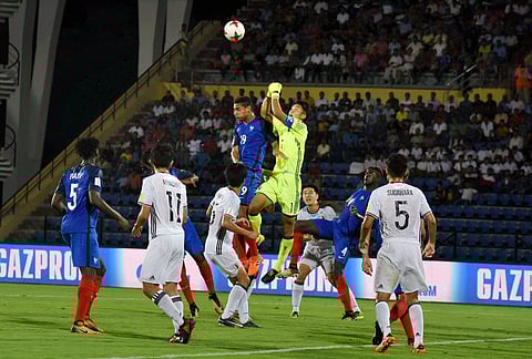 Players of France in blue jersey and Japan in white jersey vie for the ball during their U-17 FIFA world cup football match at Indira Gandhi Athletics Stadium Sarusajai in Guwahati on Wednesday. | PTI
