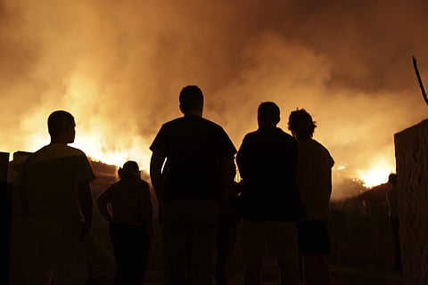 Wildfires in Portugal killed at least 27 people, injured dozens more and left an unconfirmed number of missing in the country's second such tragedy in four months, officials said Monday. (AP Photo)