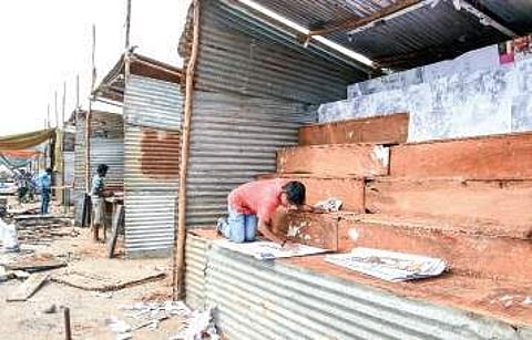 Workers erecting temporary sheds to sell firecrackers at Swaraj Maidan in Vijayawada on Monday | Express