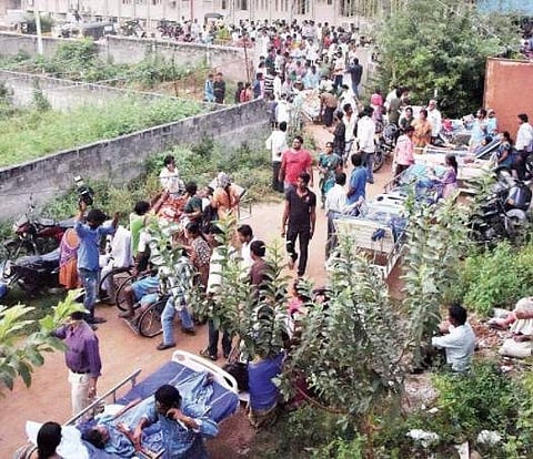 Patients being shifted by their family members out of Rohini Super Speciality Hospital, where a fire broke out, to other hospitals in Warangal on Monday |Express photo
