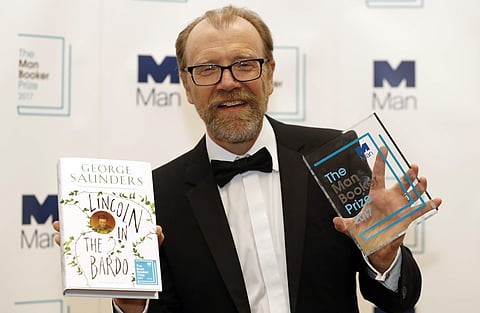 Author George Saunders of the United States with his book 'Lincoln in the Bardo' during a photocall after being announced winner of the 2017 Man Booker Prize, in London, Tuesday, Oct. 17, 2017. (AP)