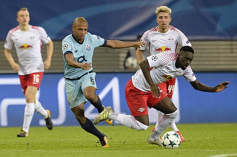Porto's Yacine Brahimi, left, battles for the ball with Leipzig's Jean-Kevin Augustin, right, during the Champions League Group G first leg soccer match. | AP