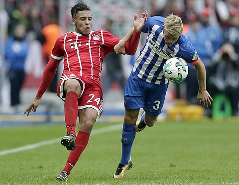 Bayern's Corentin Tolisso, left, and Hertha's Per Ciljan Skjelbred, right, challenge for the ball during the German Bundesliga soccer match between Hertha BSC Berlin and FC Bayern Munich in Berlin, Germany. | AP