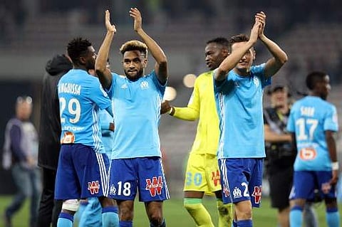 Olympique de Marseille's French defender Jordan Amavi (L) reacts with teammates at the end of French L1 football match between Nice and Marseille on October 1, 2017 at the 'Allianz Riviera' stadium in Nice, southeastern France. | AFP
