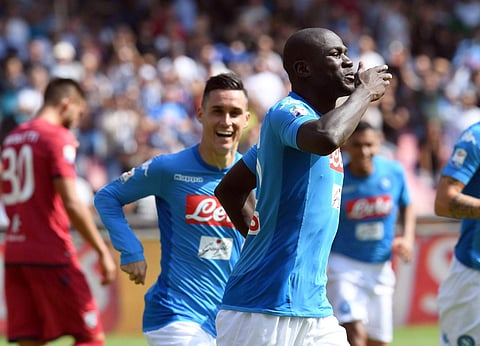 Napoli's Kalidou Koulibaly celebrates after scoring during a Serie A match soccer match between Napoli and Cagliari at the San Paolo stadium in Naples, Italy, Sunday, Oct. 1, 2017. | AP